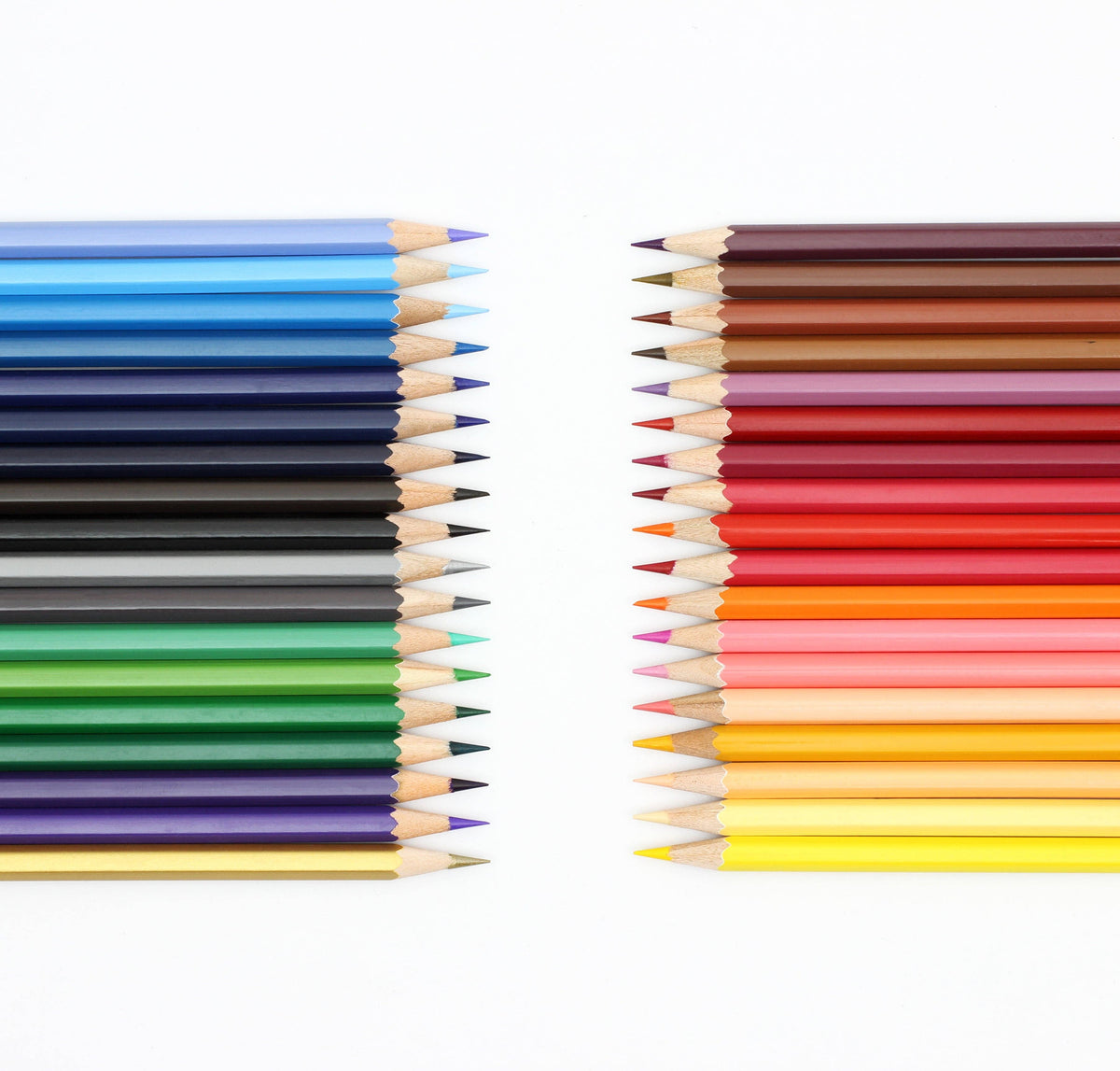 Two vertical rows of sharpened colored pencils facing each other on a white background, showing a full spectrum of colors from blues and greens to pinks, reds, oranges, and yellows.