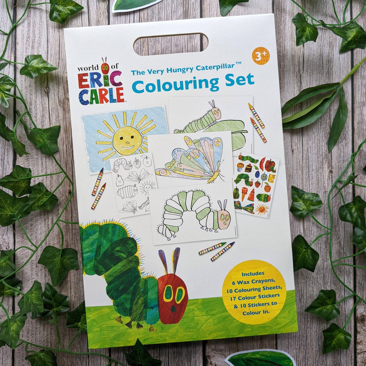 World of Eric Carle The Very Hungry Caterpillar Colouring Set packaging on a wooden surface with leaves.