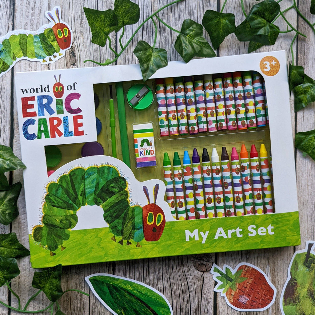 Art set packaging with 'World of Eric Carle' branding on a wooden surface with leaf decorations.