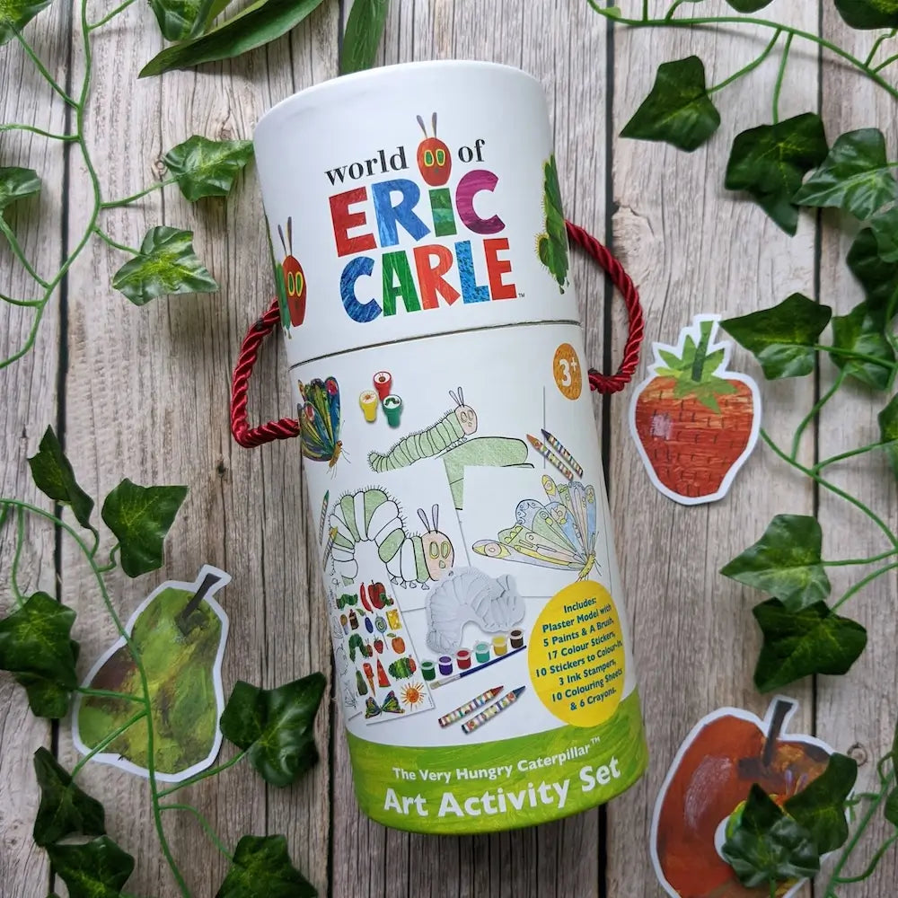 Art activity set from the World of Eric Carle series on a wooden surface with leaves.